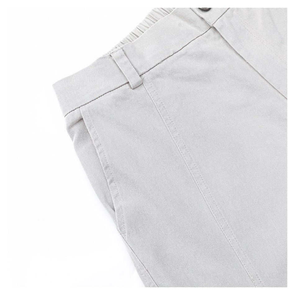 Close-up of the light gray trousers' side seam and belt loop near the waistband.