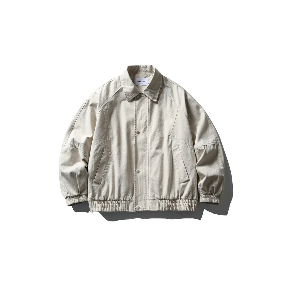 Apricot cream collared snap-front jacket with raglan sleeves, slanted pockets and elastic hem, flat lay front view