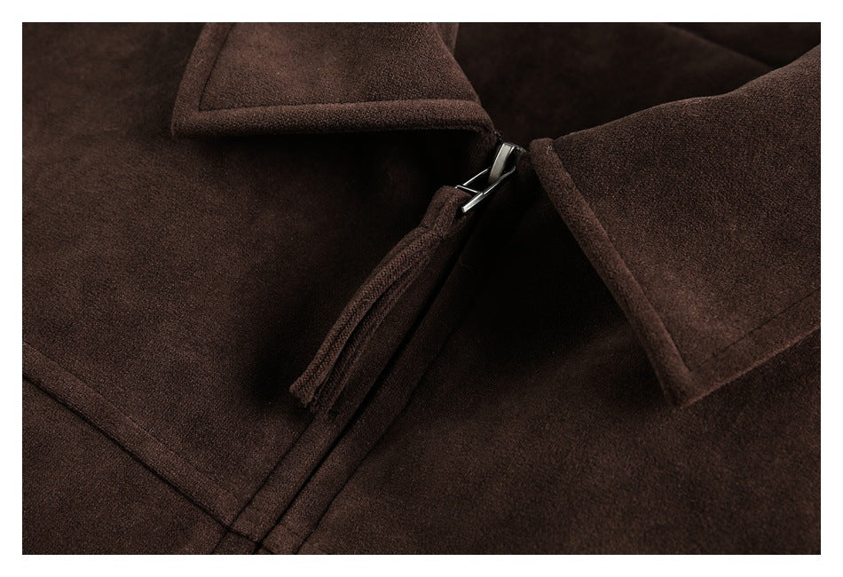 Close-up of the dark brown coat's collar and metal zipper closure.