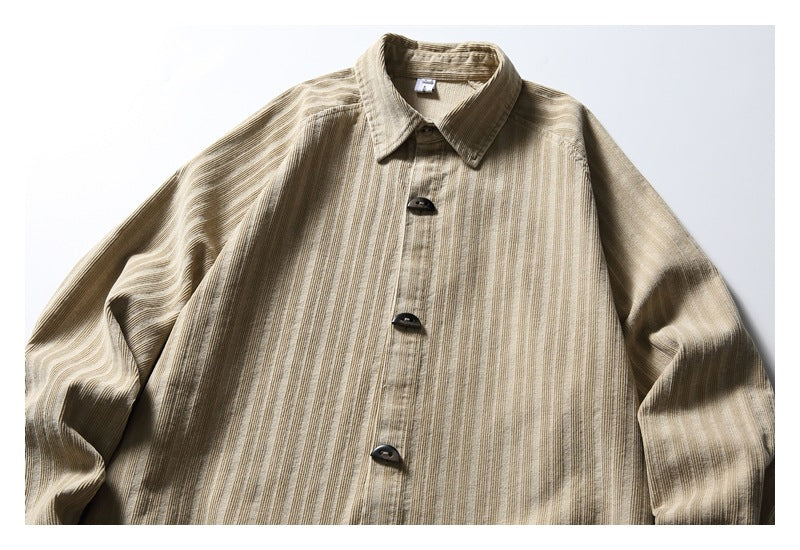 Front view of a beige long-sleeve shirt with a pointed collar, dark buttons, and narrow vertical stripes.