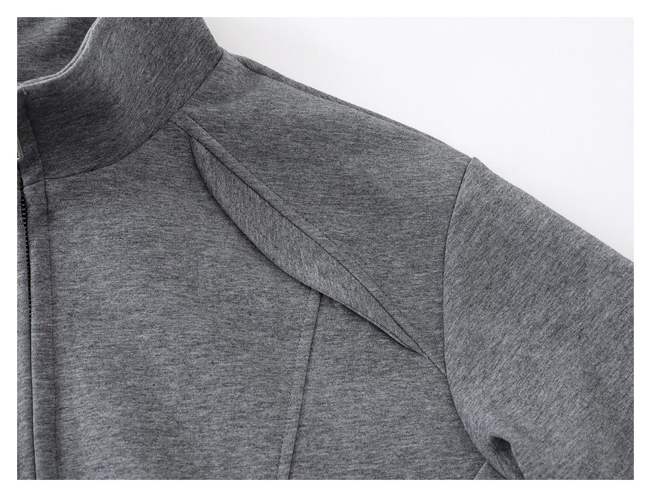 Close-up of a heather-gray jacket's high collar, shoulder seam, and sleeve.