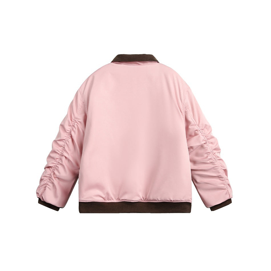 Back view of a pale pink jacket with gathered sleeves and dark brown ribbed collar, cuffs, and hem.