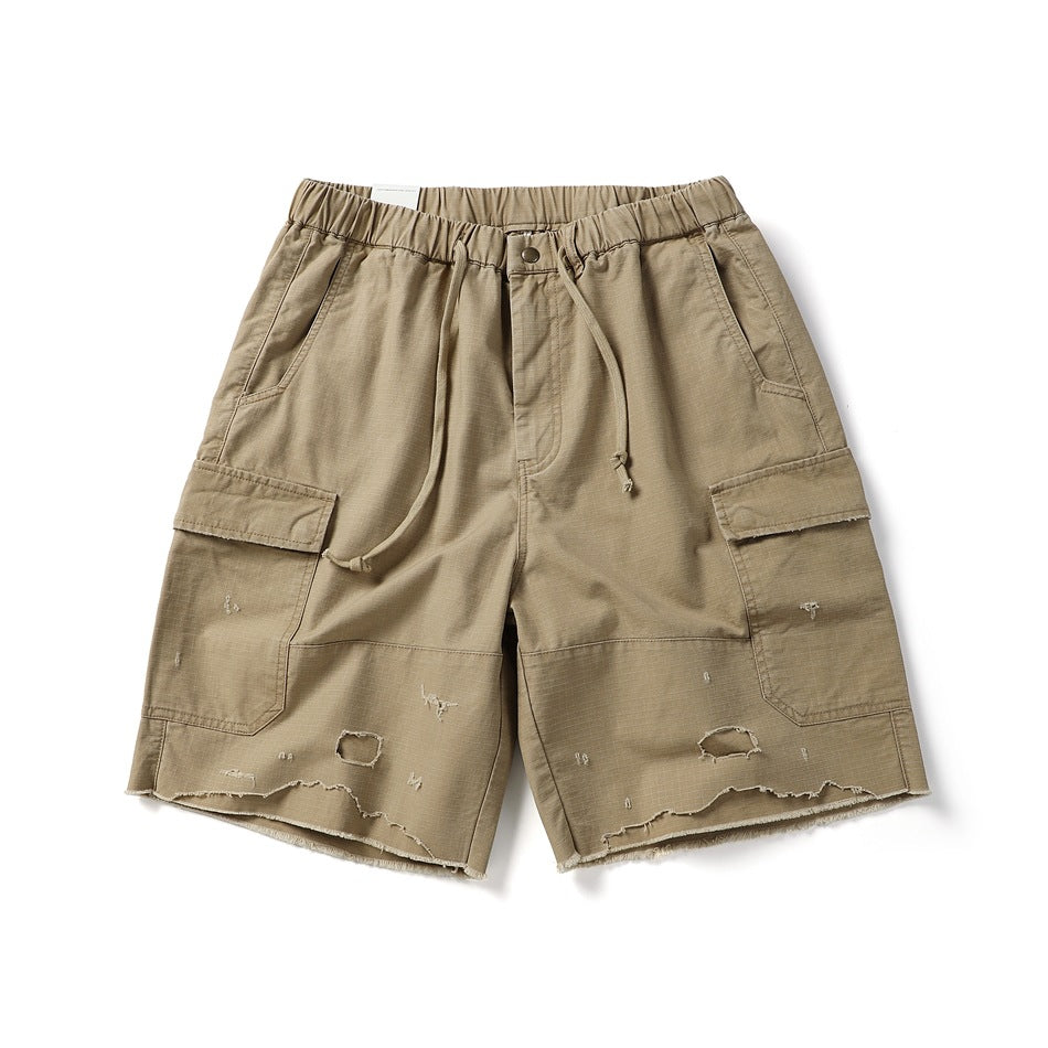 Khaki cargo shorts flat lay with elastic drawstring waist, side flap pockets and distressed frayed hem