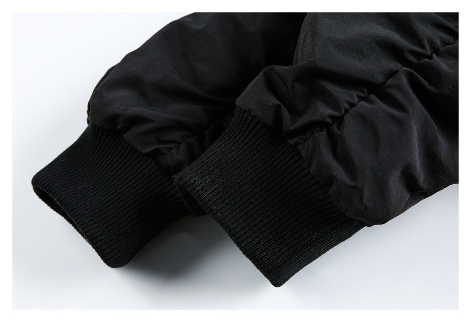 Close-up of a black jacket's ribbed knit cuffs.