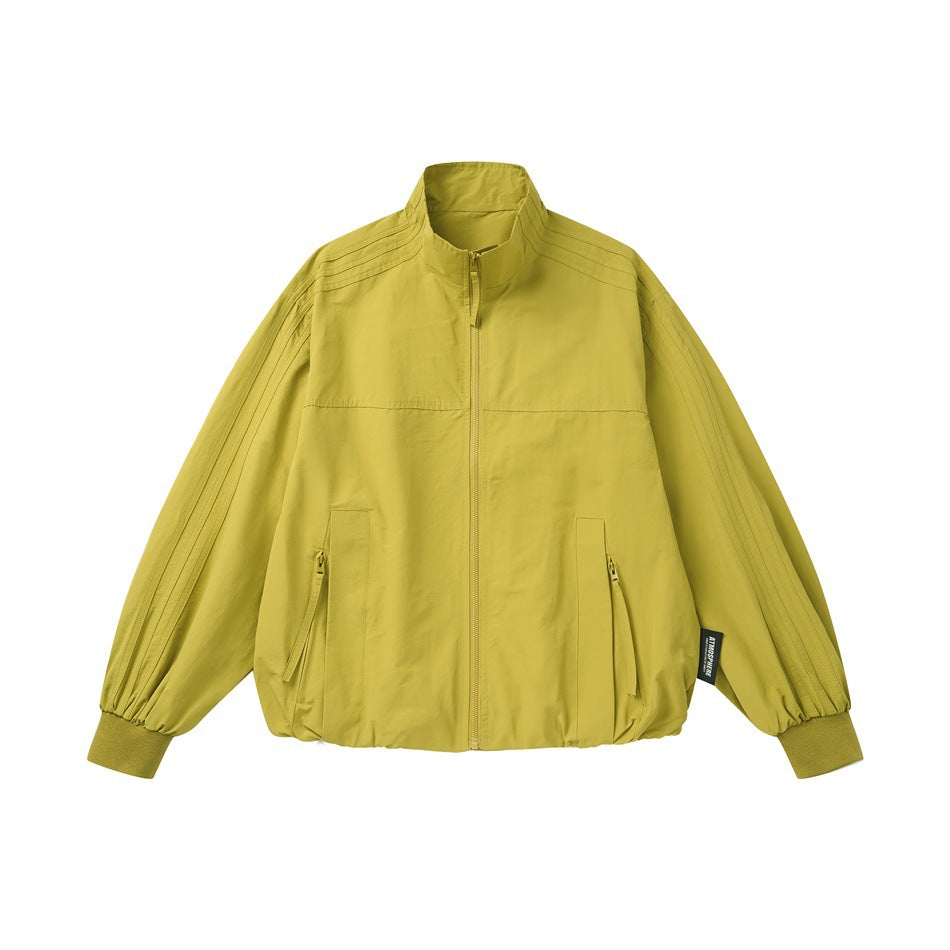 Yellow stand-collar zip jacket with zippered front pockets, ribbed cuffs and gathered hem, flat front view