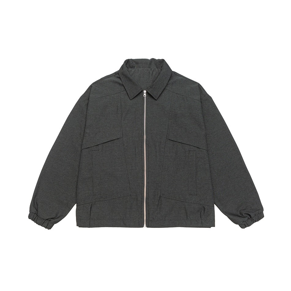 Dark gray heathered zip-front collared jacket with paneled front pockets and elastic cuffs, flat lay on white