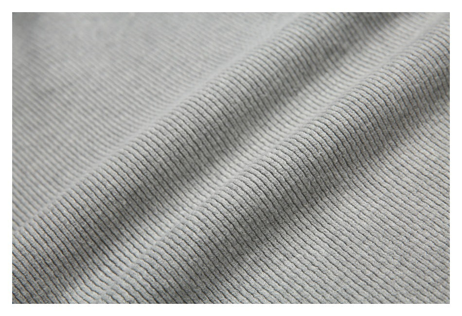 Close-up showing the fine ribbed texture and folds of light gray knit fabric.