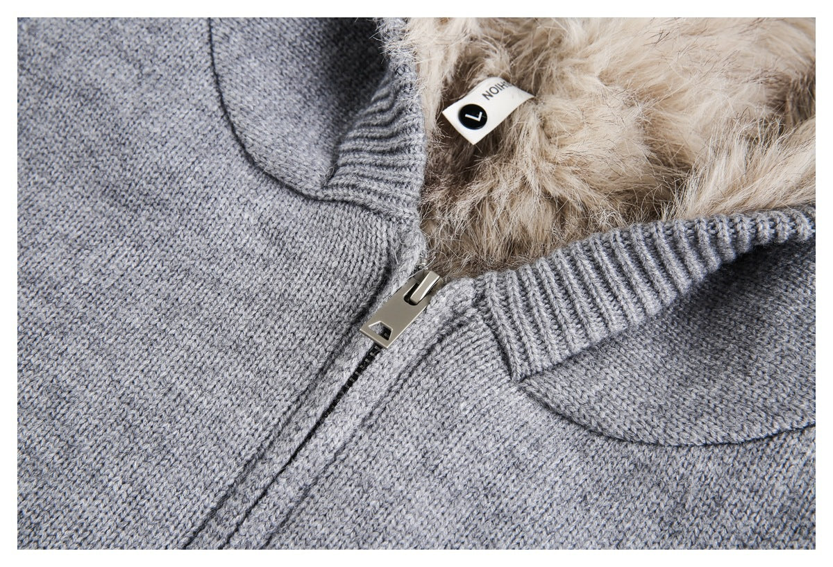 Close-up of the gray knit jacket's front zipper, ribbed edge, and beige faux-fur lining.