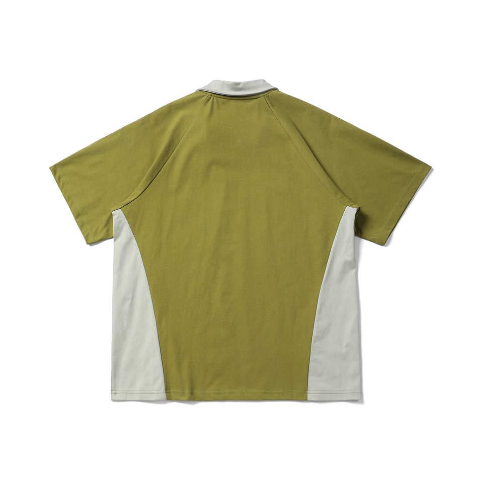 Back view of a short-sleeve color-block shirt, olive green with off-white side panels and collar.