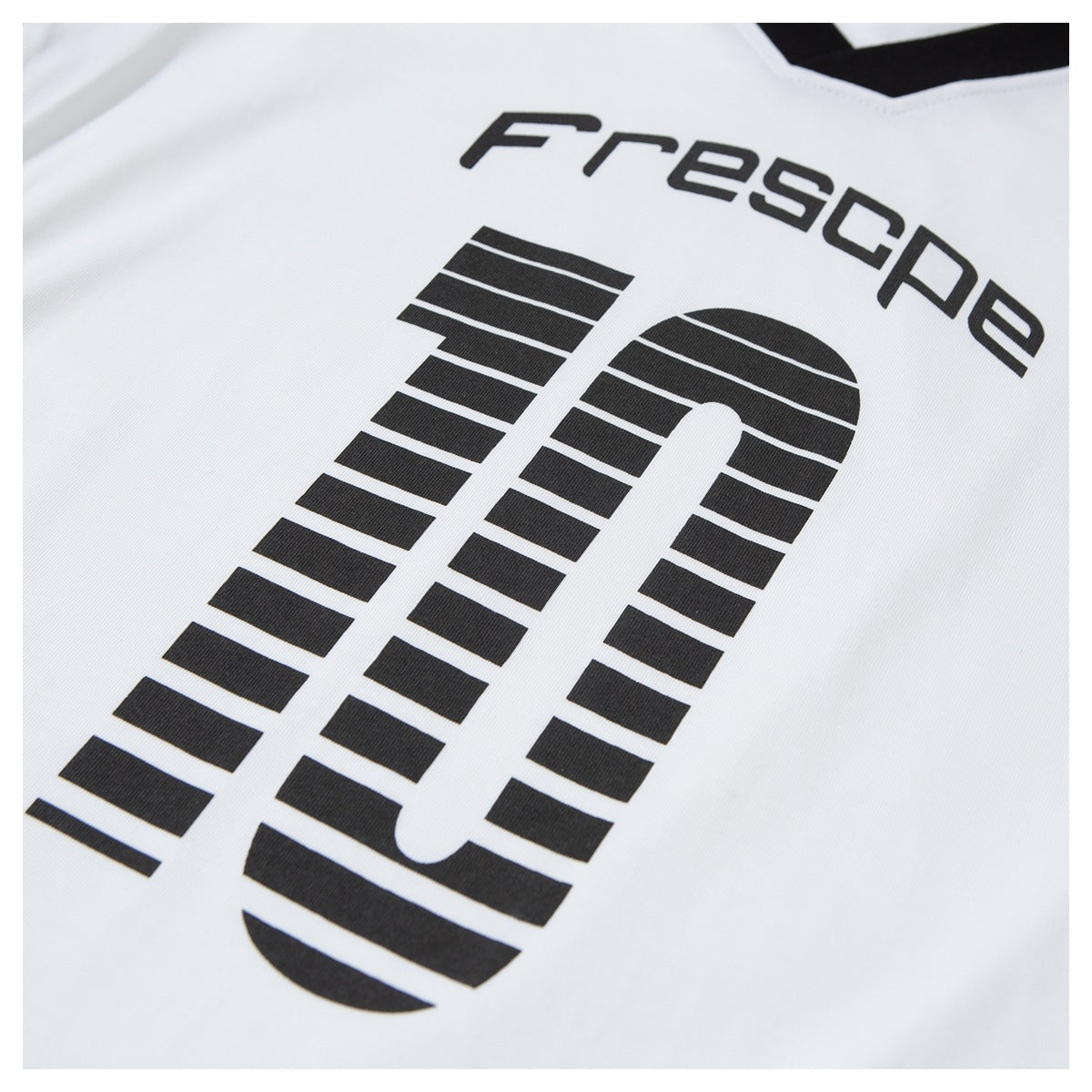 Close-up of black lettering and a large striped graphic printed on the white T-shirt.