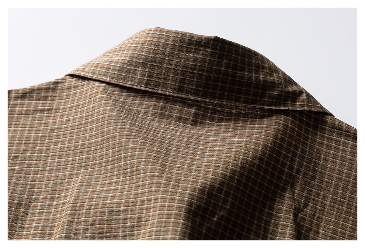 Close-up of the brown checked shirt's back collar and upper back.