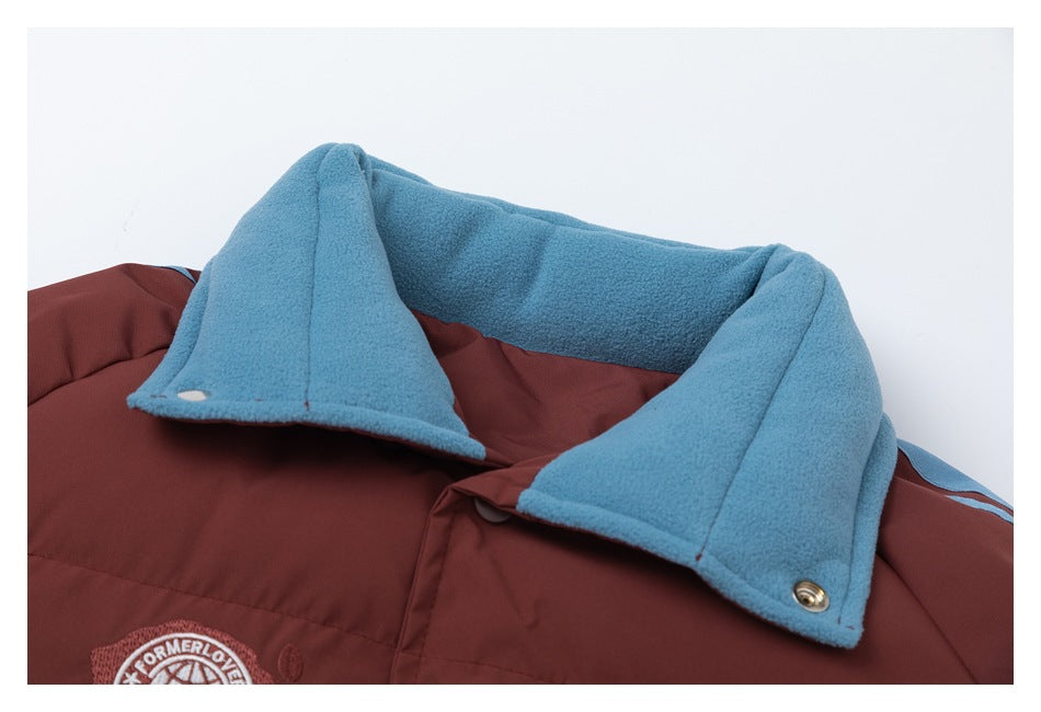 Close-up of the jacket's blue fleece collar, burgundy lining, and embroidered chest emblem.
