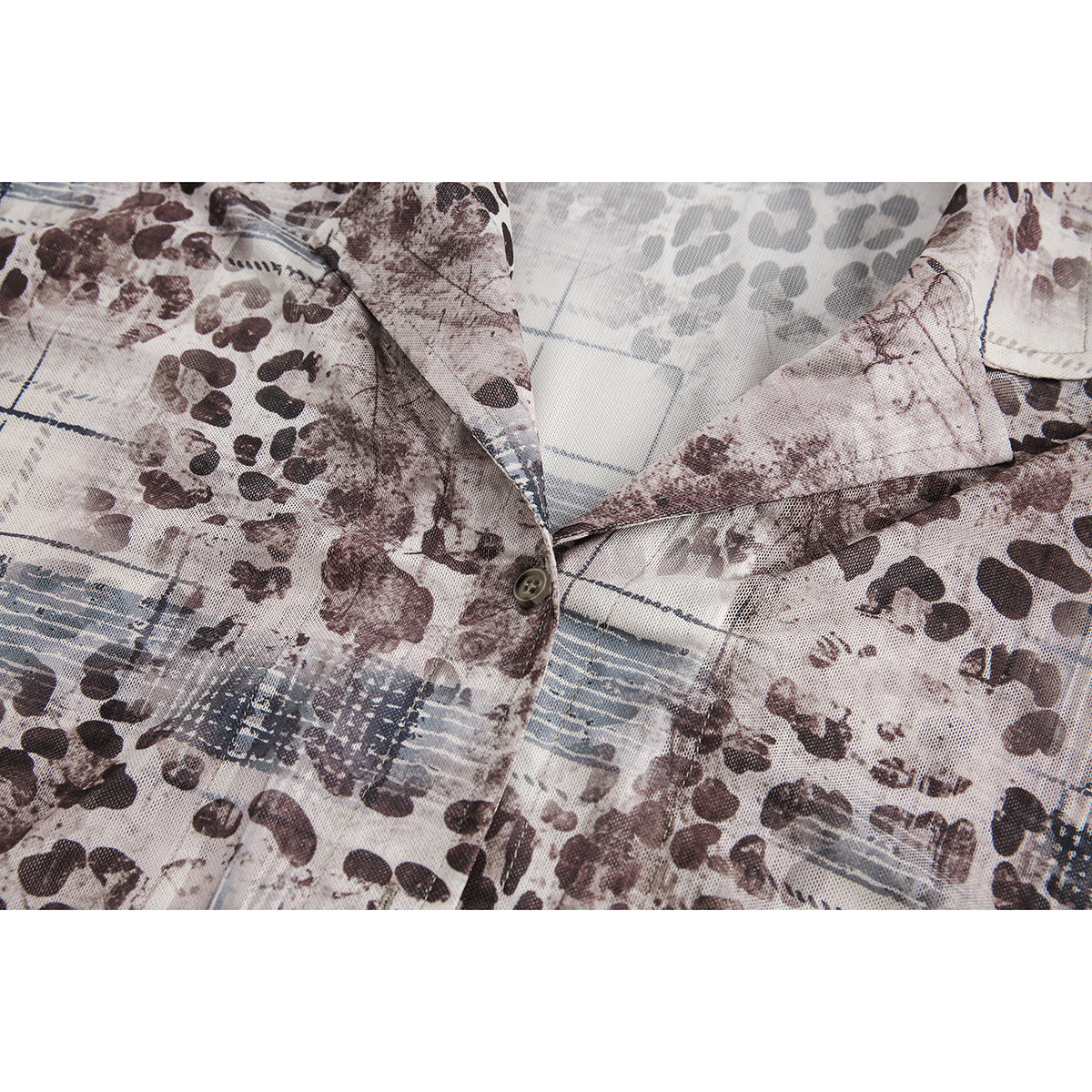 Close-up of the shirt's pointed collar and button placket in an abstract brown, gray, and blue print.
