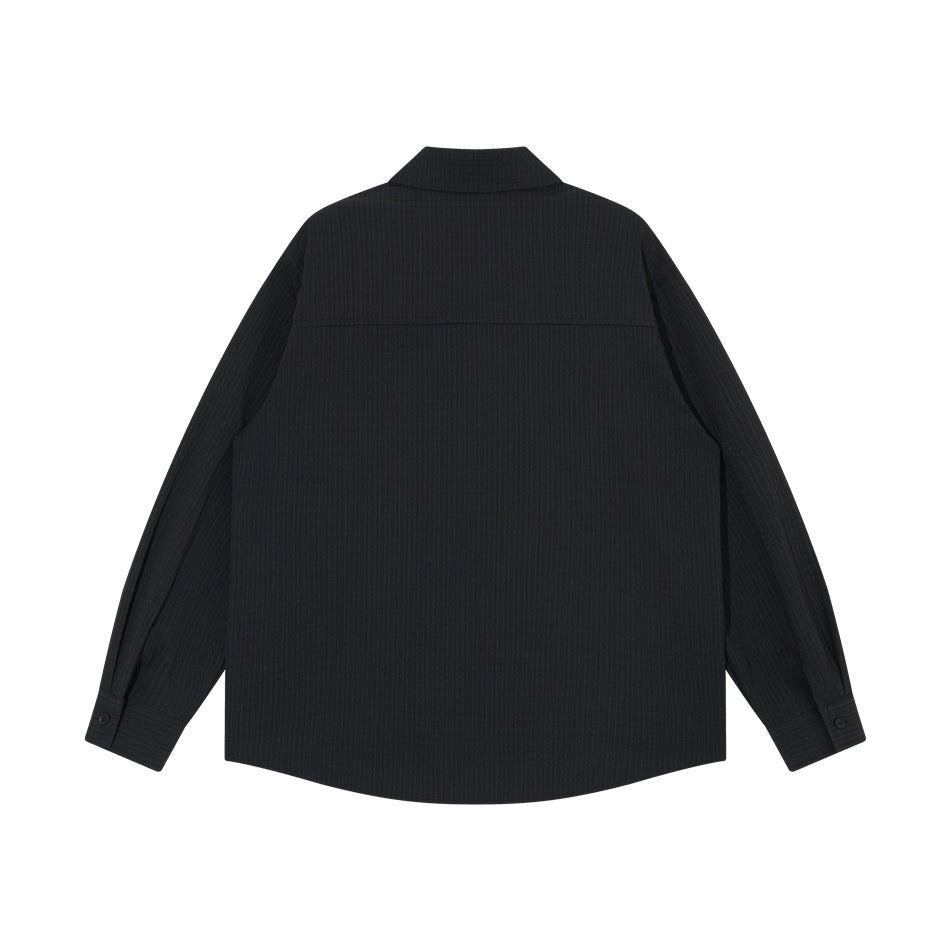 Back view of a black long-sleeved collared shirt with button cuffs and subtle textured fabric.