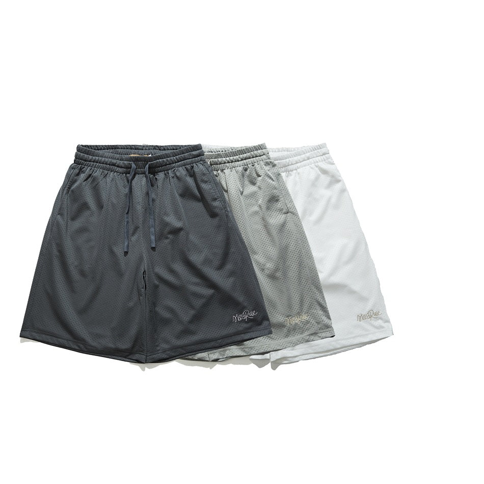 Three pairs of perforated mesh shorts shown from the front in charcoal, light gray, and white.