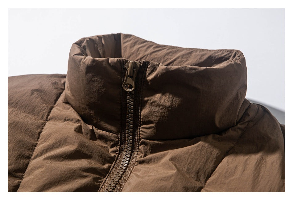Close-up of the brown padded jacket's high collar and front zipper.