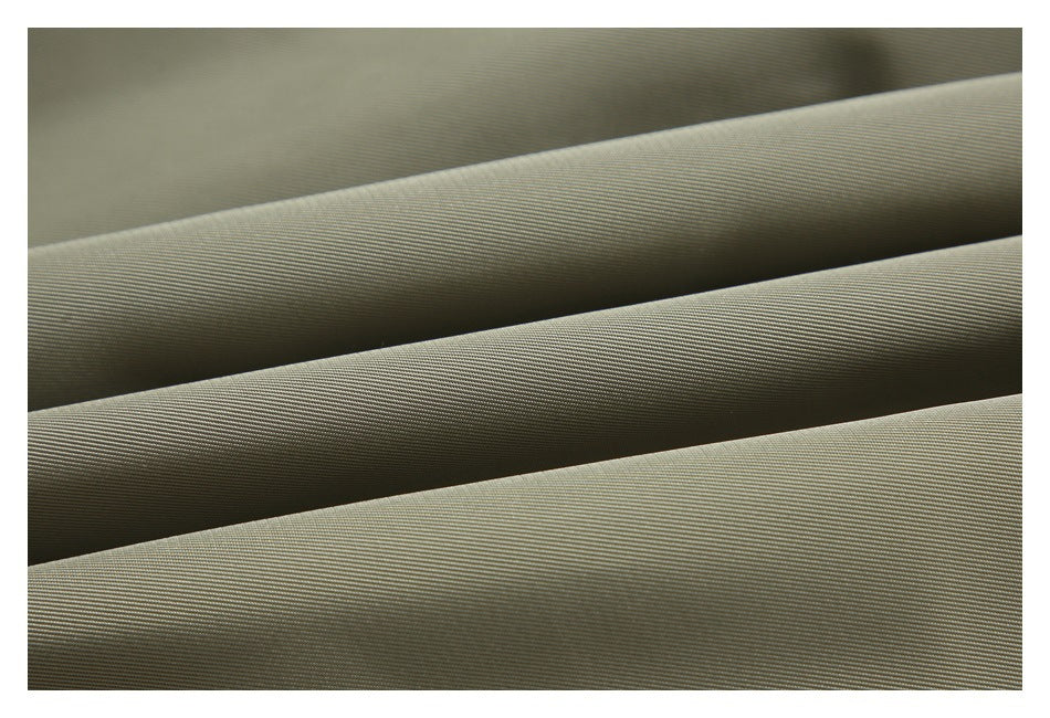 Close-up of olive-gray woven fabric arranged in parallel folds.
