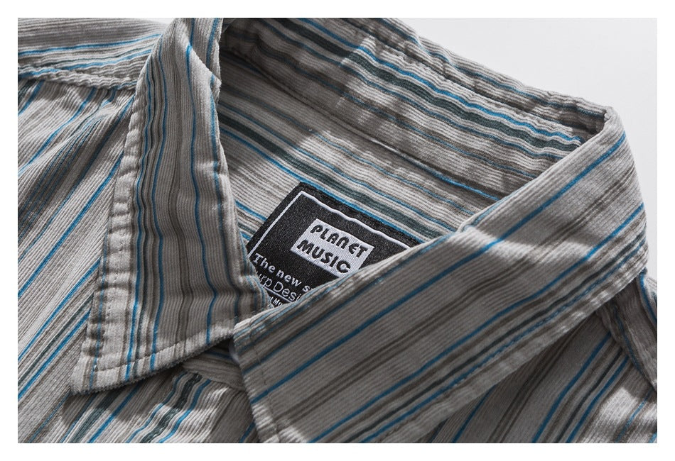 Close-up of a gray striped shirt collar and its black woven neck label.
