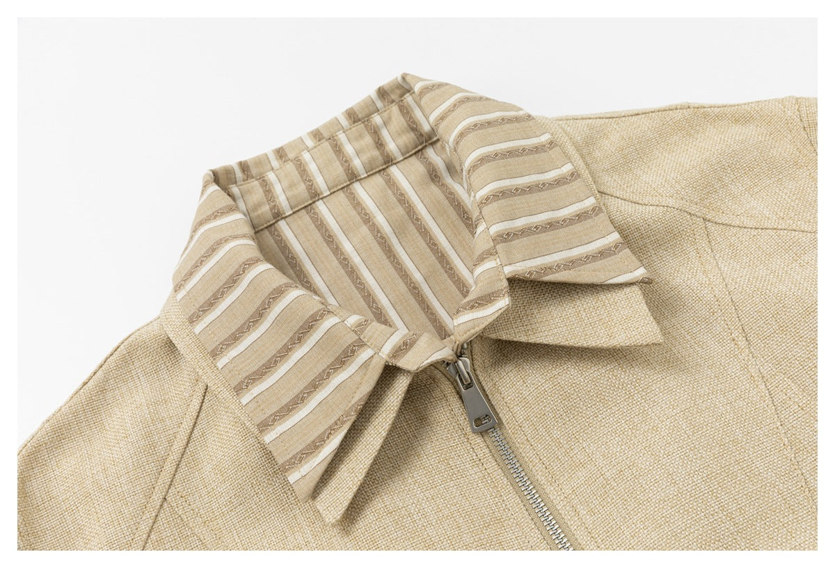 Close-up of the jacket's striped collar, beige woven-look fabric, and front zipper.