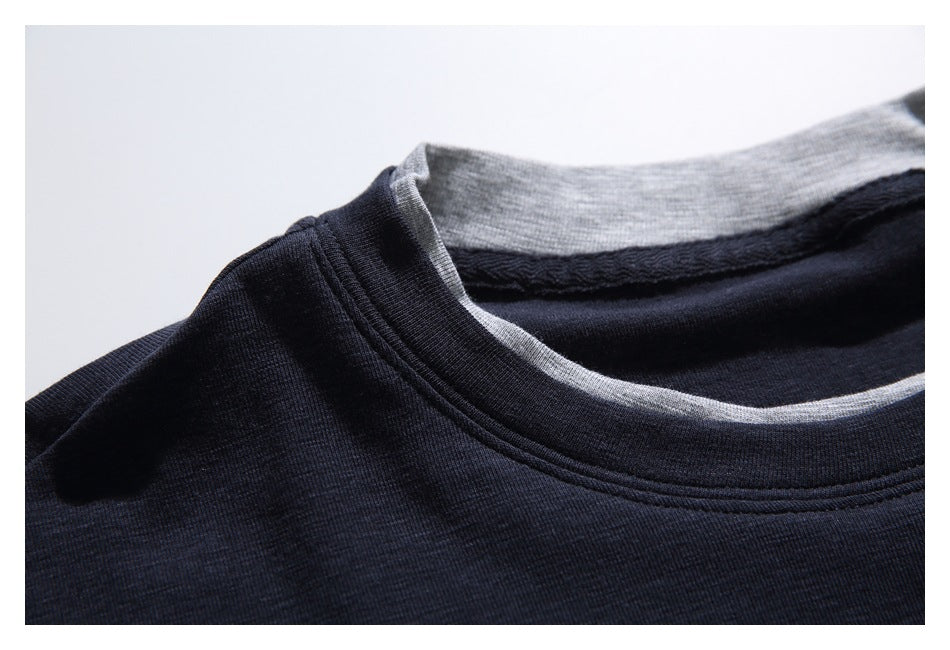 Close-up of a dark navy crew neckline with gray contrast fabric visible inside the collar.