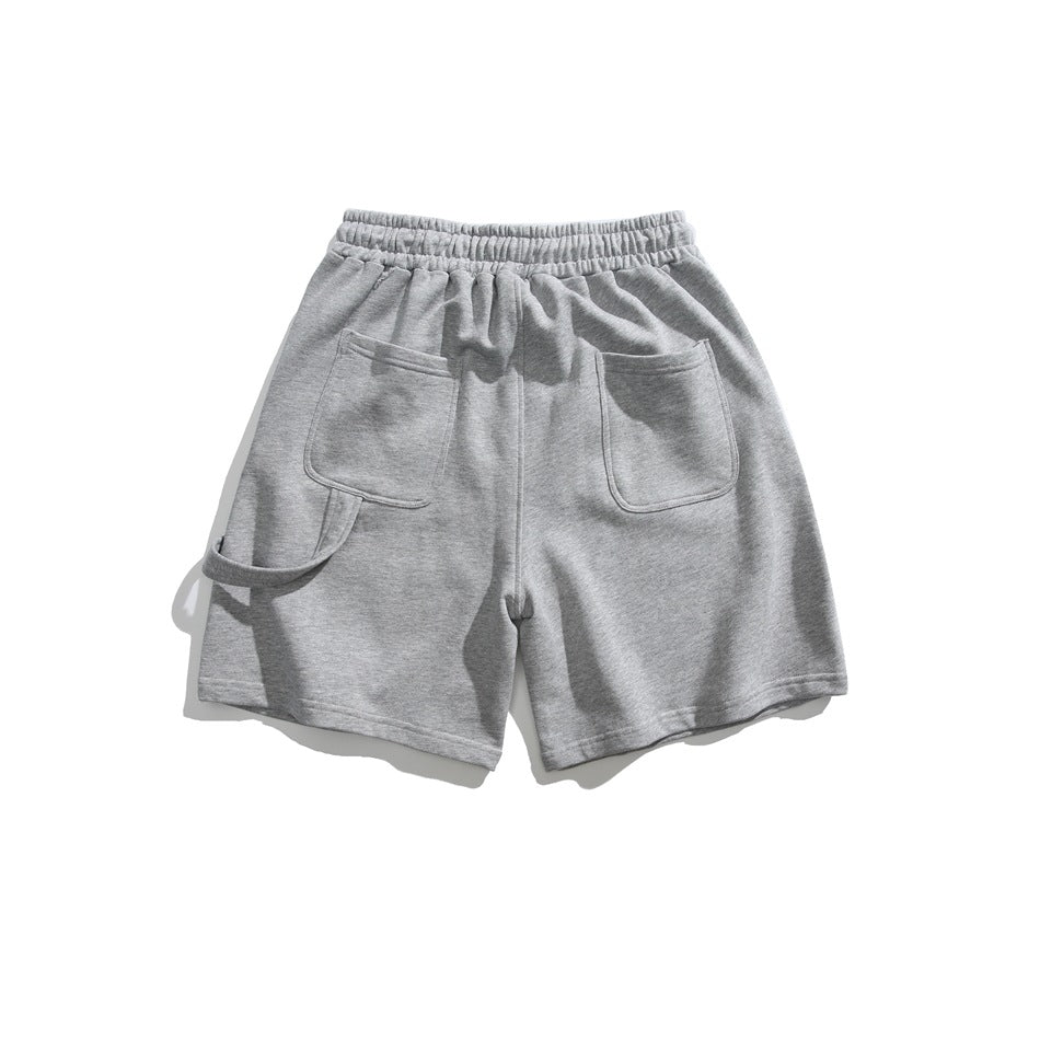 Light gray shorts shown from the back, with an elastic waistband, two patch pockets, and a side utility loop.