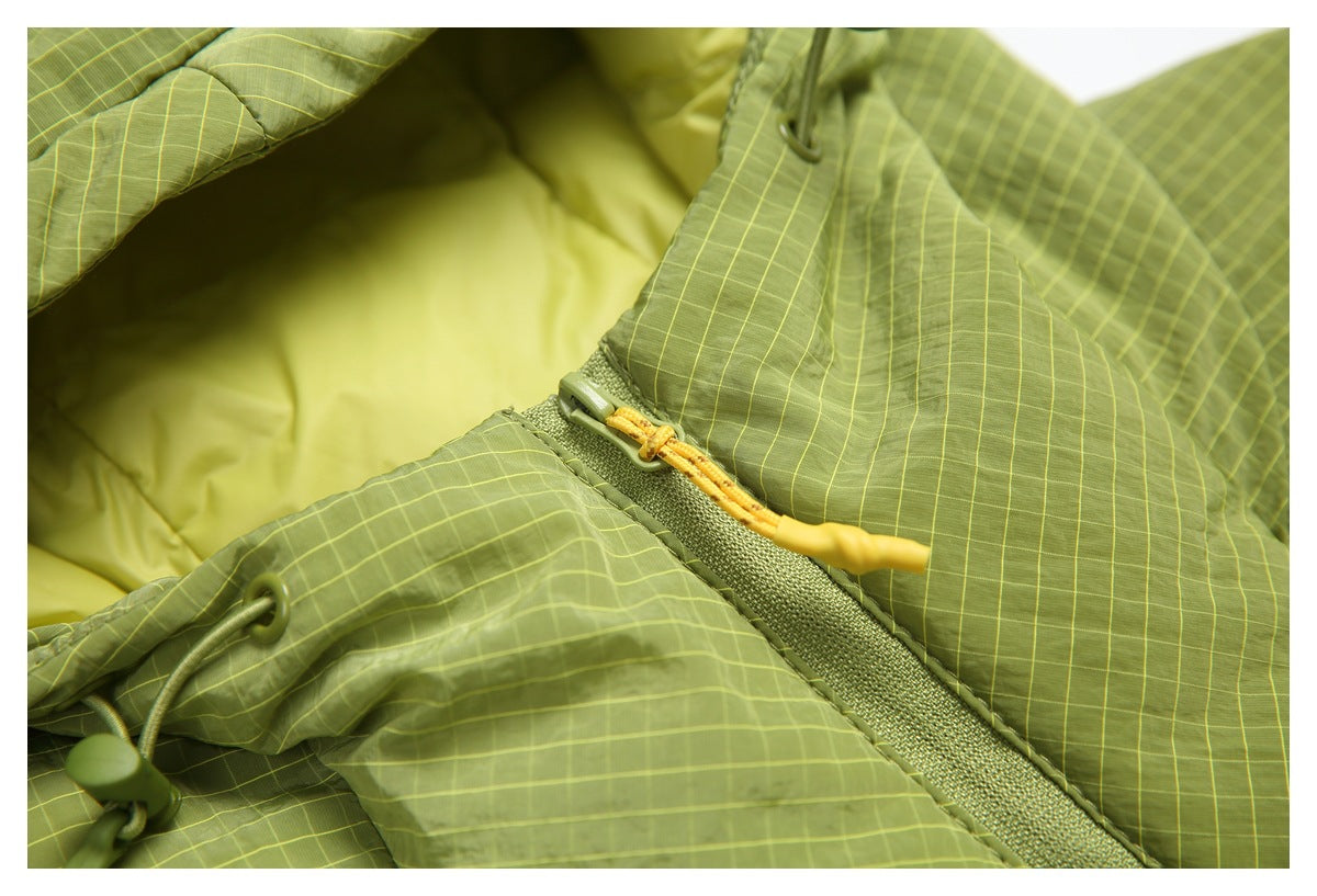 Close detail of the jacket's hood lining, green grid-pattern shell, drawcord, and yellow zipper pull.