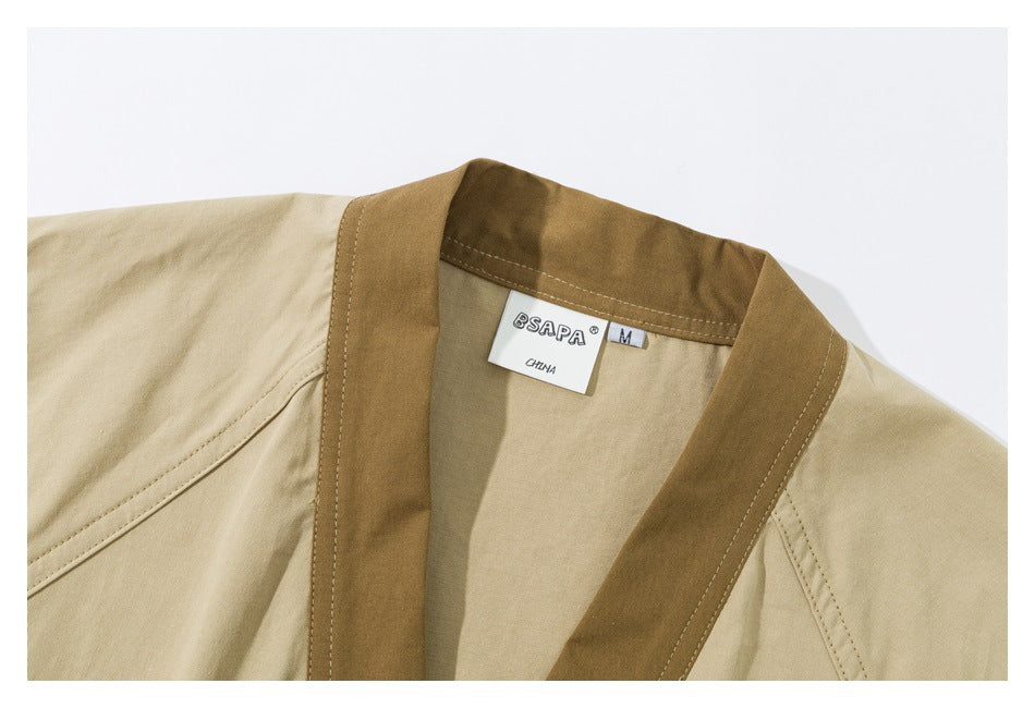 Close-up of a beige jacket's brown collar trim and neck label.