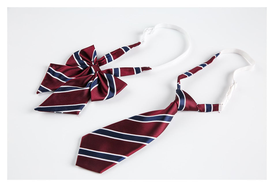 Burgundy bow tie and matching necktie with navy and white diagonal stripes, displayed flat on a white background.