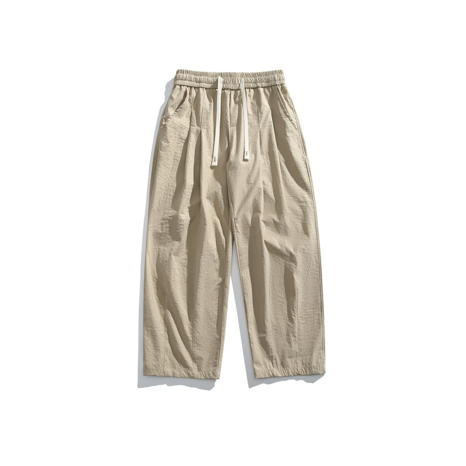 Khaki wide-leg drawstring pants with elastic waistband and front pleats, flat lay front view