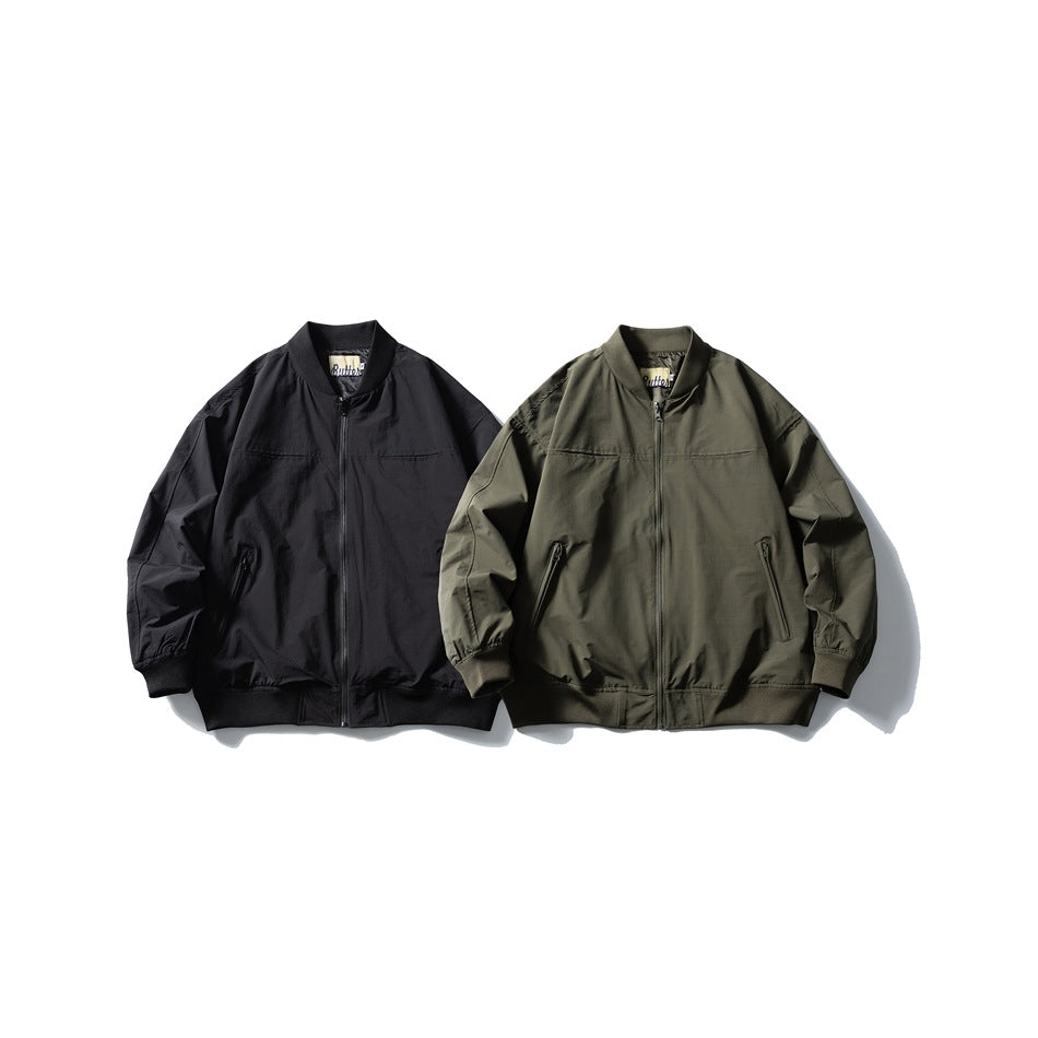 Front views of two zip-front bomber jackets in black and olive, with ribbed collars, cuffs and hems.