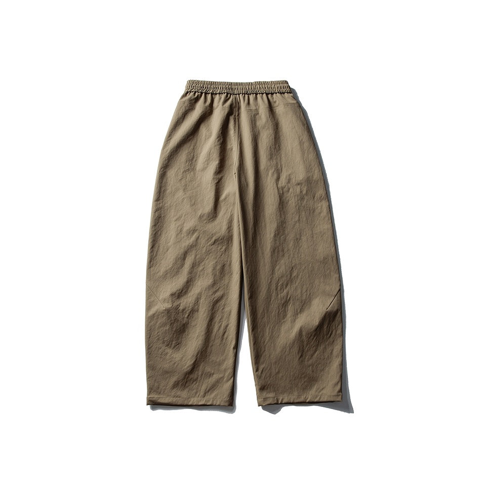 Khaki wide-leg pants flat lay, back view, with an elastic back waistband and wide straight legs
