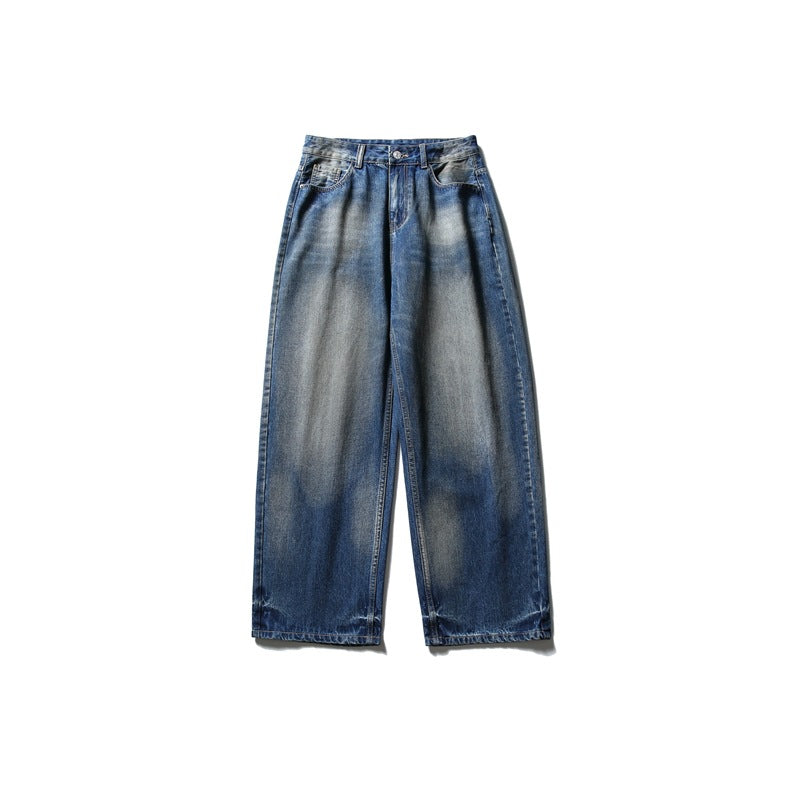 Blue wide-leg washed denim jeans with gray-tan faded areas, flat lay front view