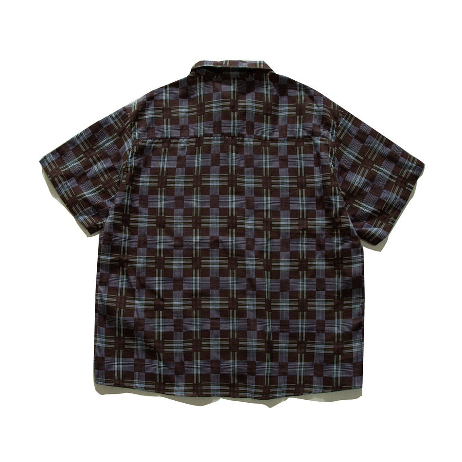 Back view of a brown and slate-blue checkered plaid short-sleeve shirt with yoke seam, flat lay