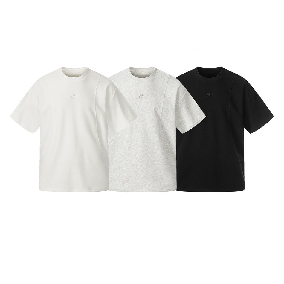 Three oversized crew-neck T-shirts shown together in white, heather gray, and black.