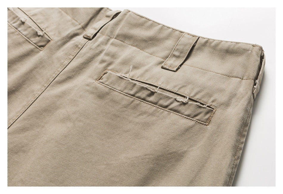 Close-up of beige trousers showing a single rear welt pocket and waistband belt loops.