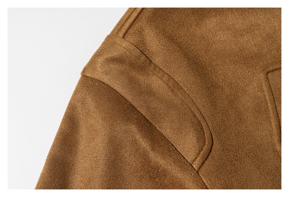 Close-up of a camel-brown coat showing a curved shoulder seam and textured fabric.