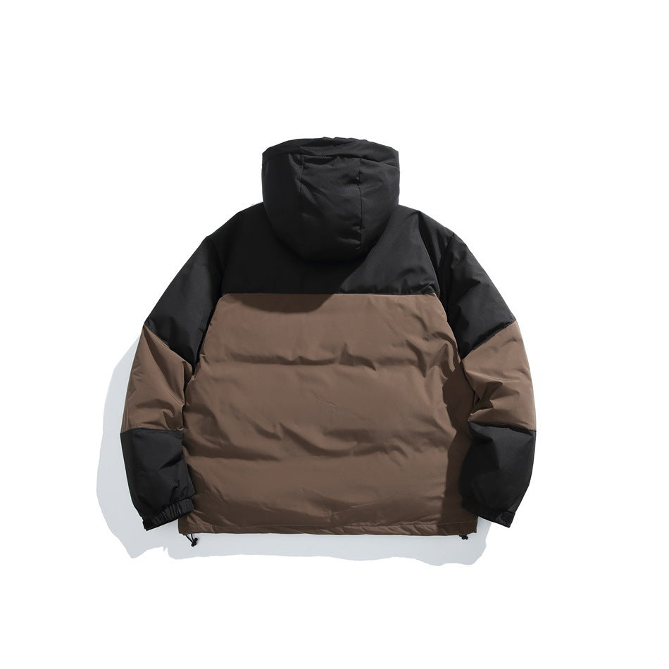 Back view of a hooded jacket laid flat, with a black upper section and sleeves and a brown lower body.