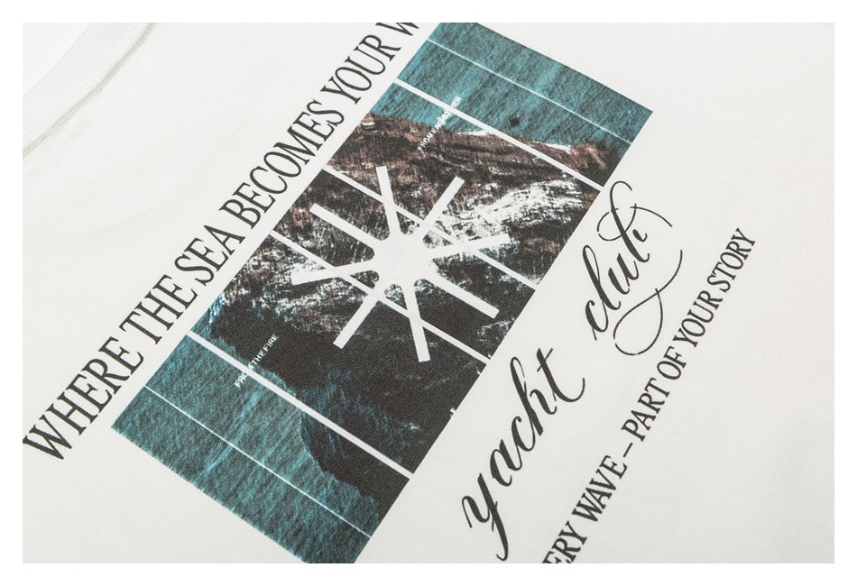 Close-up of a printed ocean-themed graphic and English lettering on an off-white T-shirt.