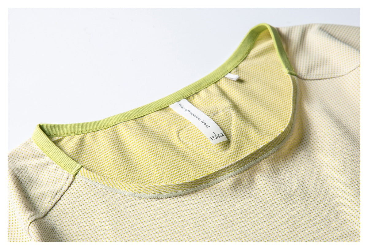Close-up of a pale yellow patterned top's bound neckline and sewn size label marked L and 170/88A.