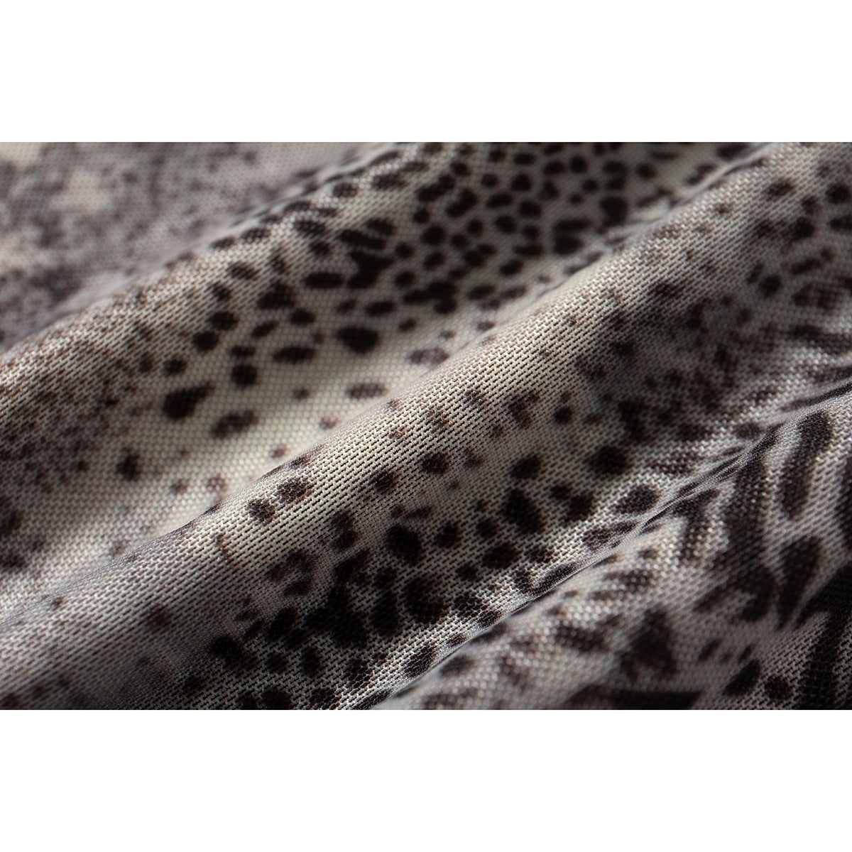 Extreme close-up of the skirt's gray and black animal-print fabric.