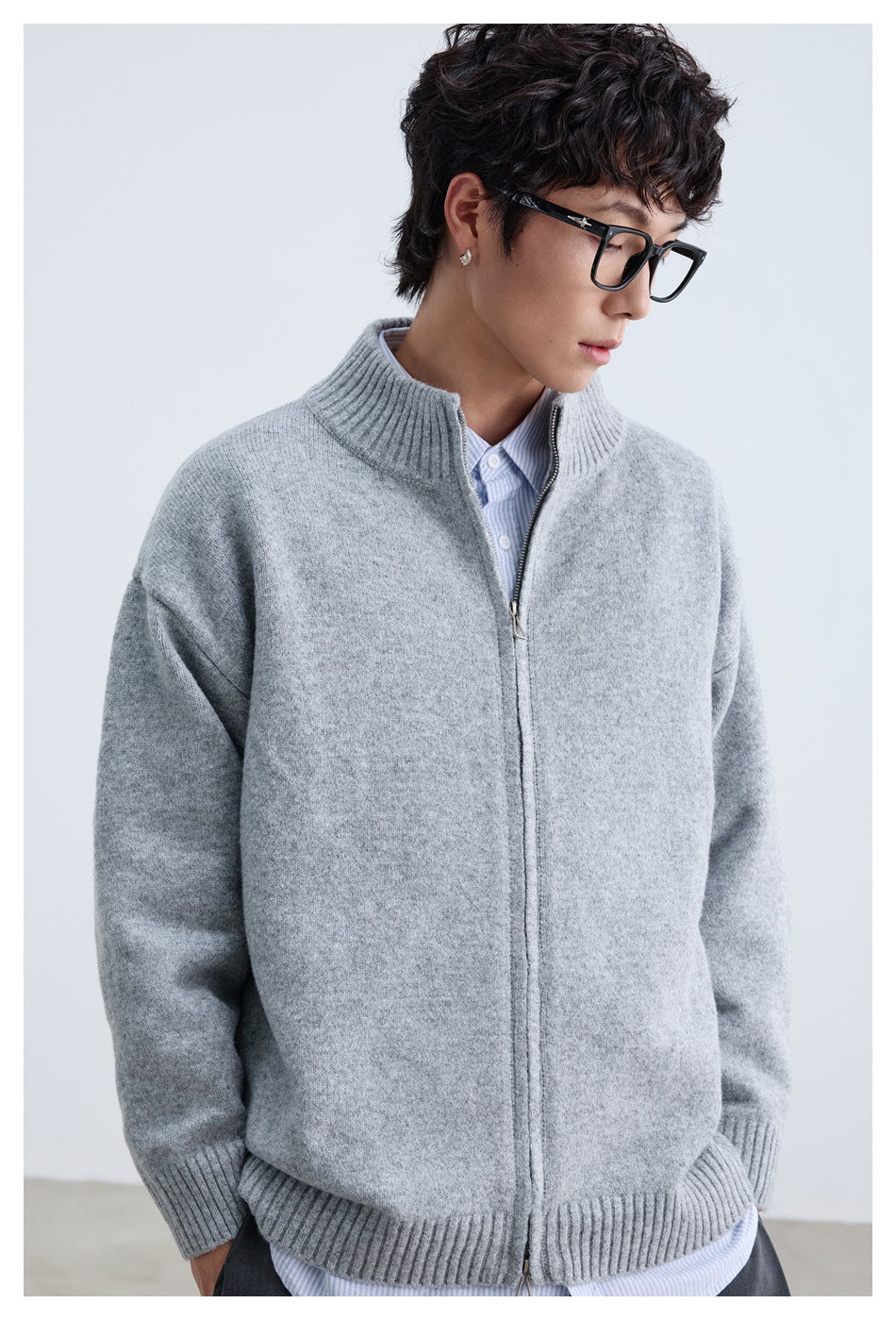 Model wearing a light gray zip-front knit cardigan with a ribbed stand collar, cuffs, and hem.