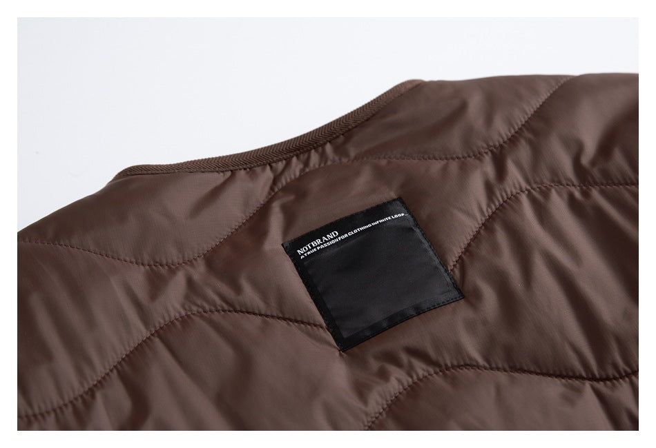 Close-up of the brown jacket interior, showing quilted panels and a black neck label.