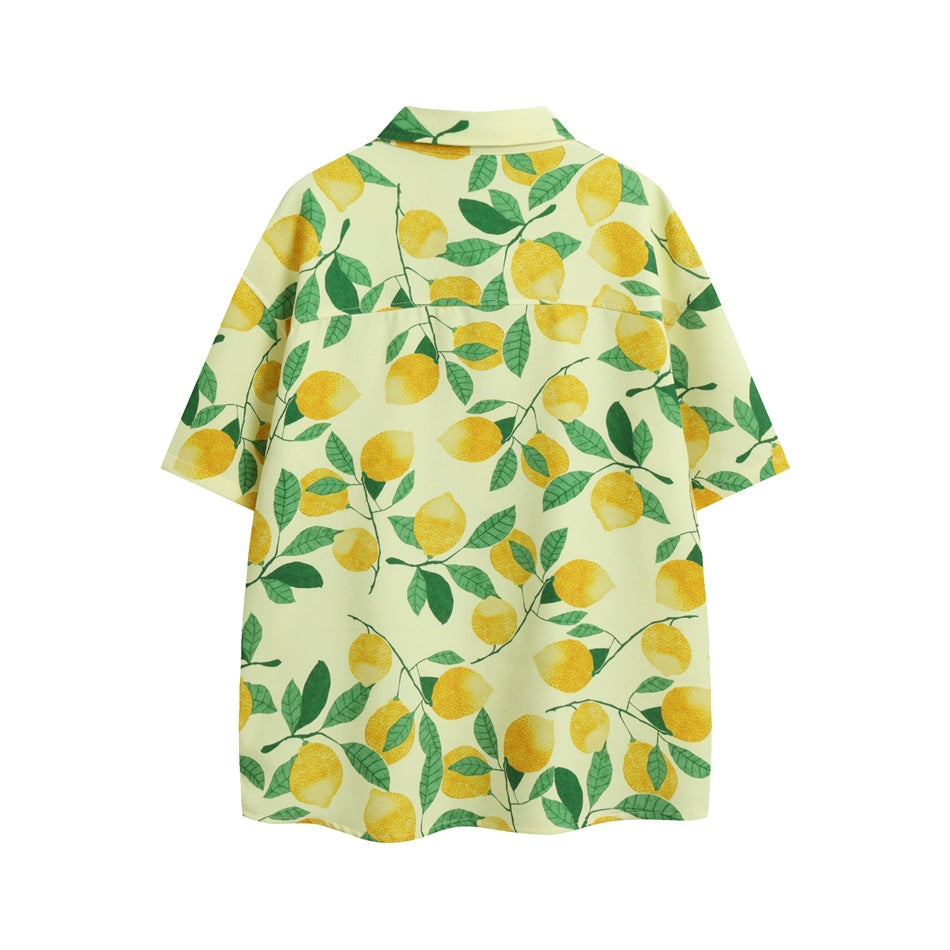 Back view of a pale yellow short-sleeve button-up shirt covered in yellow lemons and green leaves.
