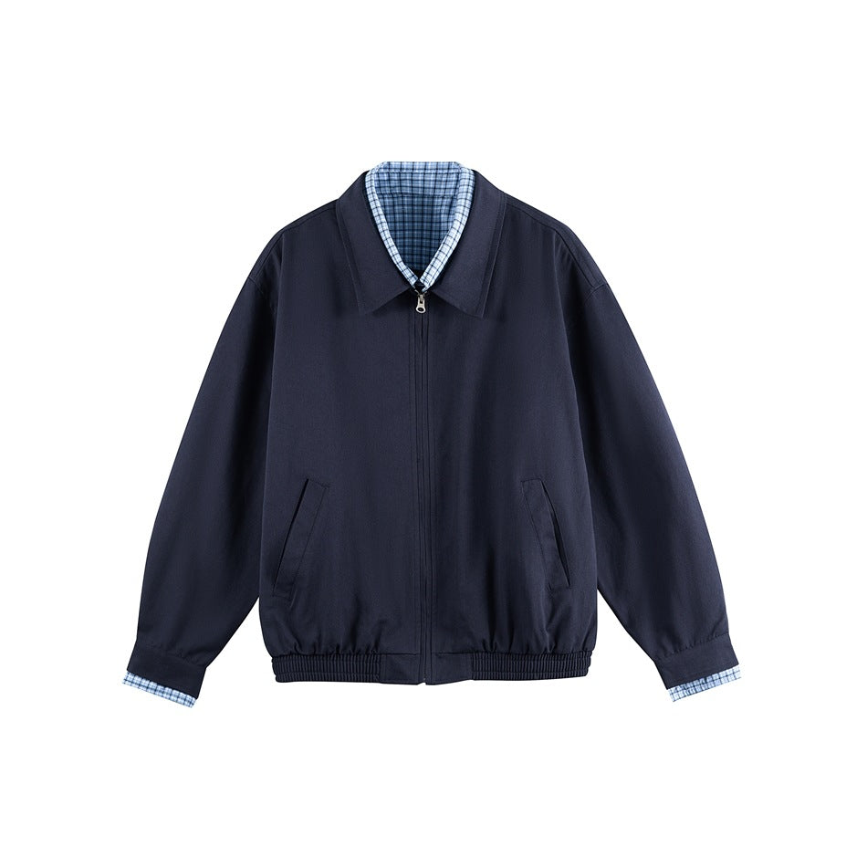 Navy blue zip-front jacket with pointed collar, angled pockets, ribbed hem and blue check trim at collar and cuffs