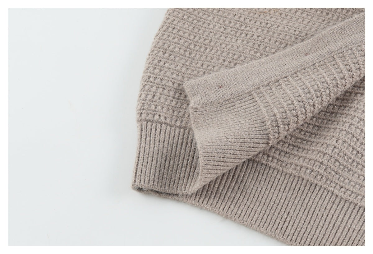 Close-up of the taupe cardigan's ribbed hem and cuff with textured knit fabric.