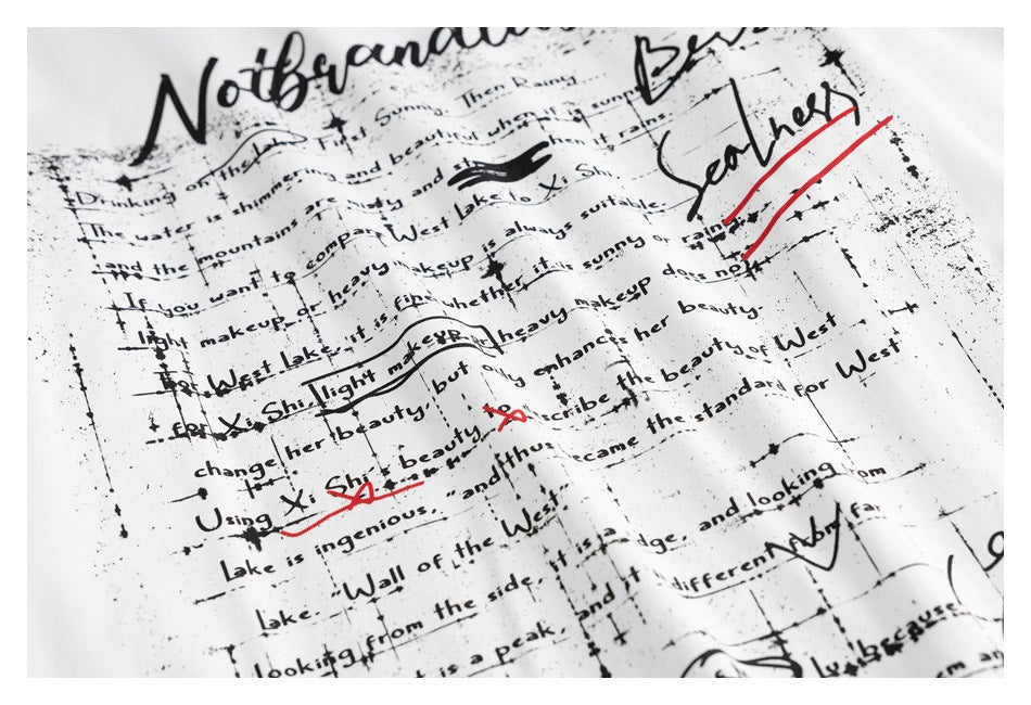 Close-up of a white shirt printed with dense black handwritten-style English text and red marks.
