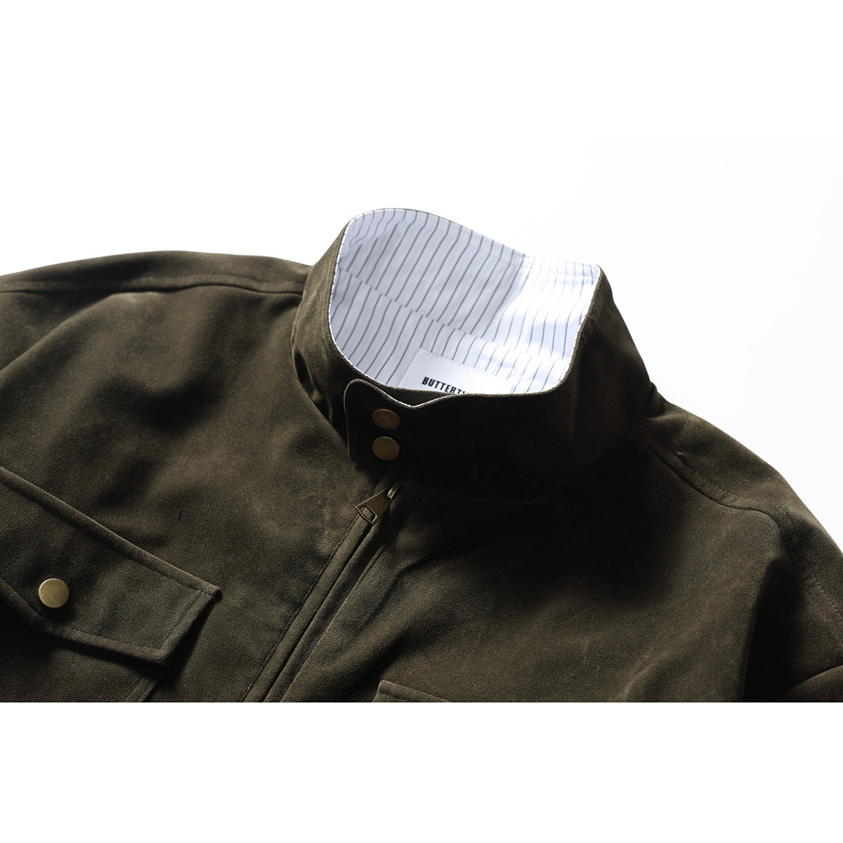 Close-up of a dark olive jacket showing its stand collar, striped inner lining, front zipper and brass-tone snaps.