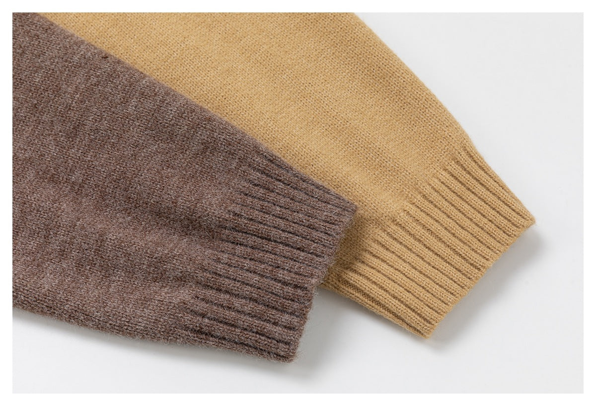 Close-up of brown and camel cardigan sleeves with ribbed cuffs.