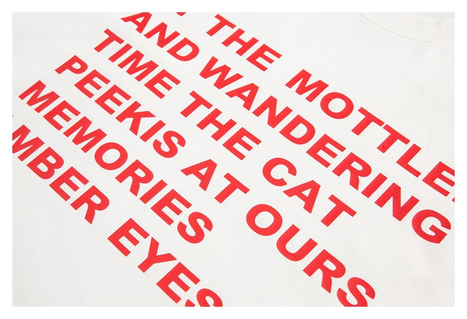 Close-up of bold red text printed diagonally across white T-shirt fabric.
