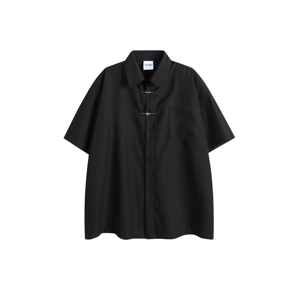 Black short-sleeve button-front shirt with chest pocket and two metal heart clasps, flat front view